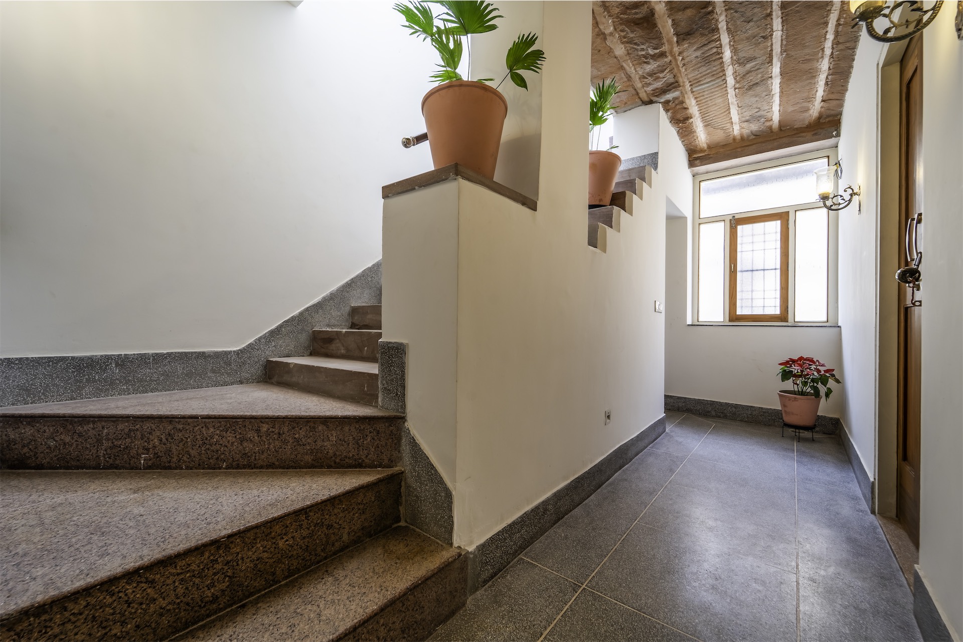 Staircase with patterned tile landing