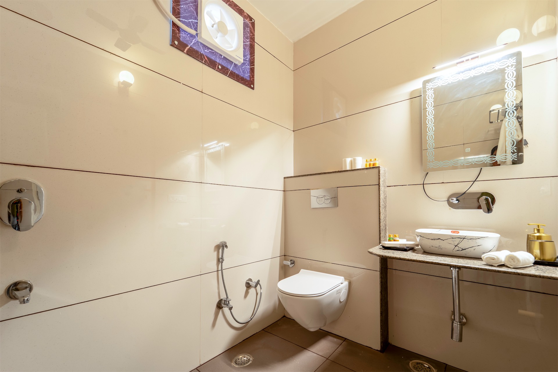 Comfort Suite bathroom — warm tones and marble basin