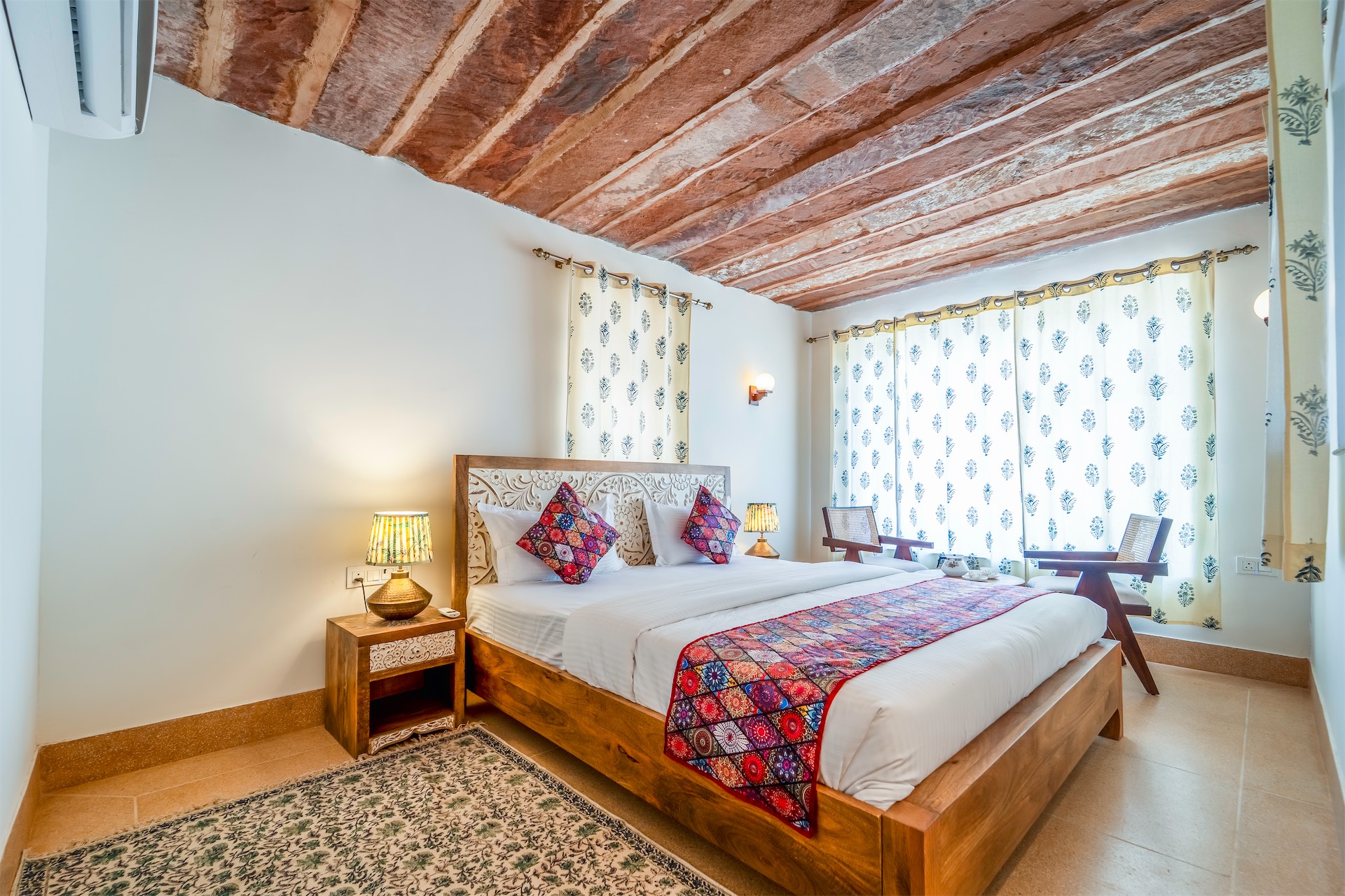 Comfort Suite — sitting area with Rajasthani art