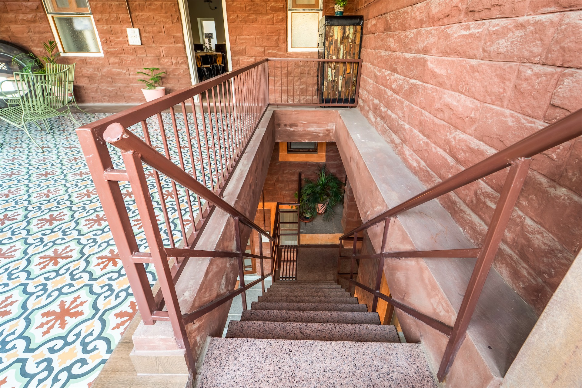 Sandstone stairway with patterned tile landing